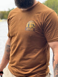 Man wearing a caramel 'Muskoka Master Baiters' t-shirt outdoors.